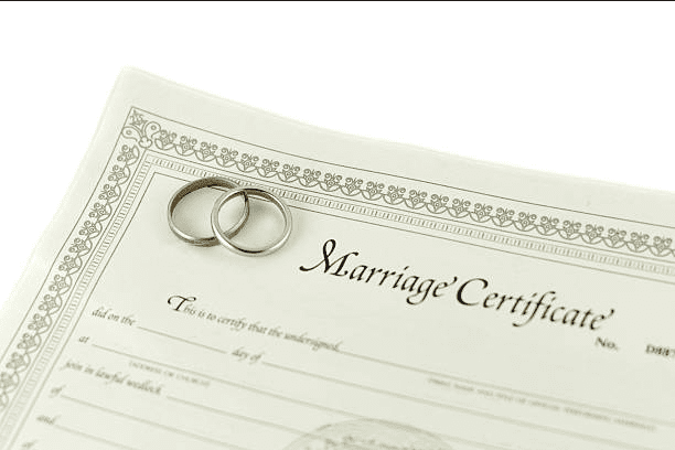 Couple showcasing their translated marriage certificate for their marriage-based green card application.