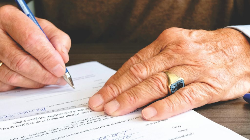 Man Signs a Legal Document